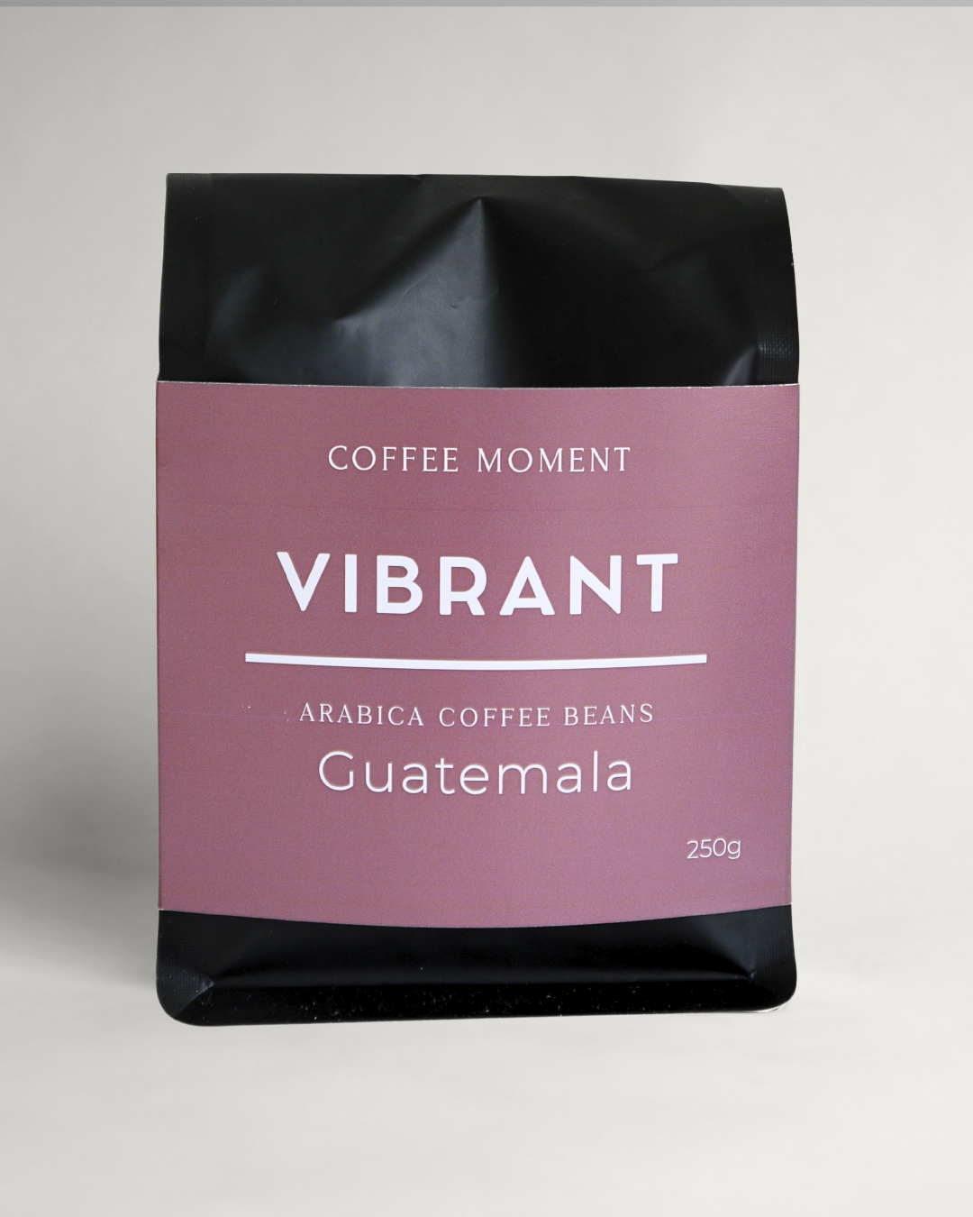 Coffee bean package with 'Vibrant' label on a gray background